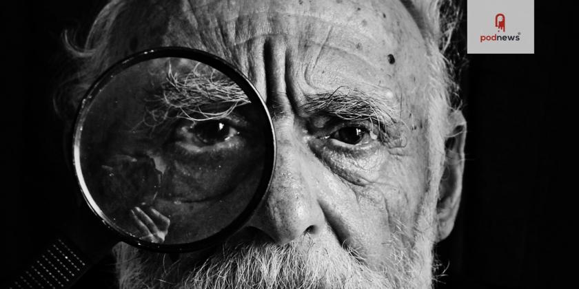 An old man with a magnifying glass