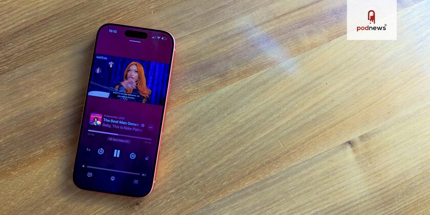 An iPhone on a cheap IKEA table showing a video in Apple Podcasts