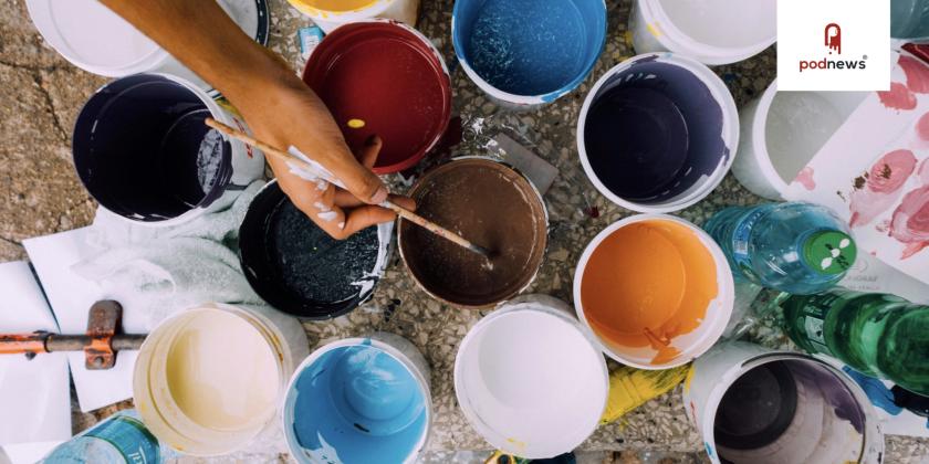Paint pots and a person painting with a brush