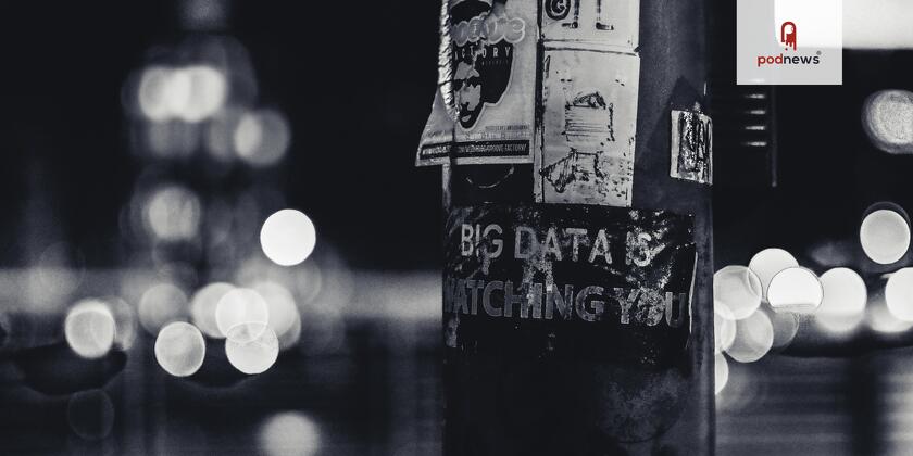 A pole with some stickers on it, including 'big data is watching you'