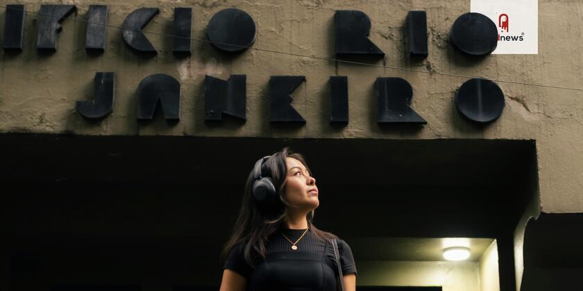 A woman wearing headphones in Rio