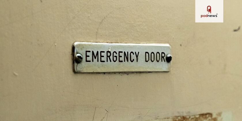 A painted sign saying 'emergency door'