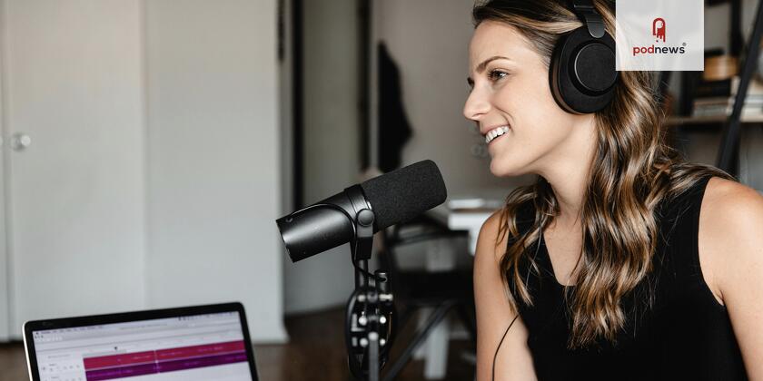 A podcast guest - a woman in a chair sitting close to a microphone