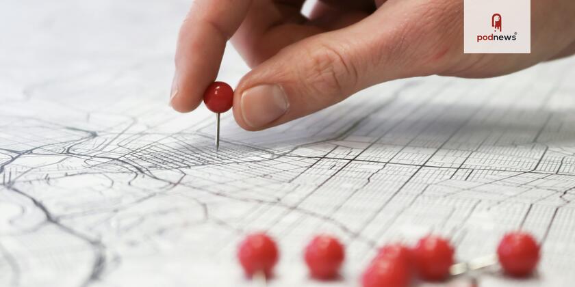 Someone putting a pin in a map
