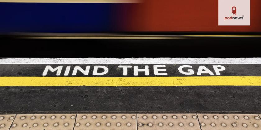 A train passing by a sign saying Mind The Gap on the London Underground