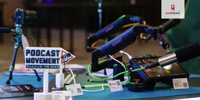 Some microphones with a Podcast Movement badge