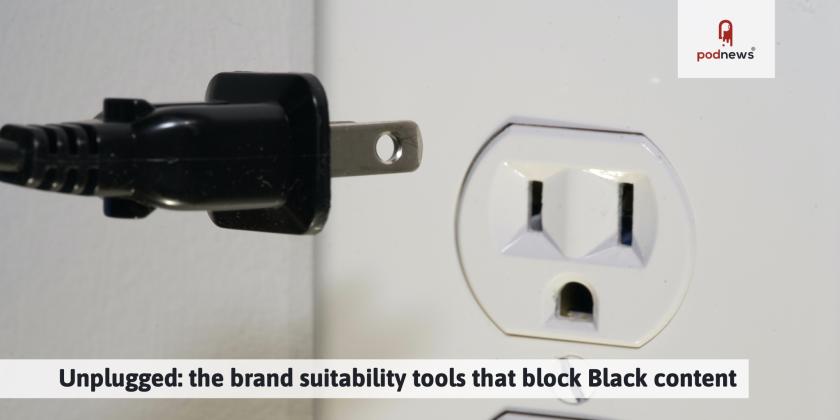 A black plug being pulled out of a white socket