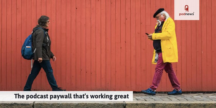 Two people in front of a red wall