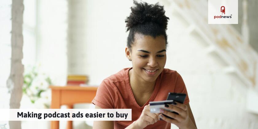 Someone excitedly buying something on their mobile phone