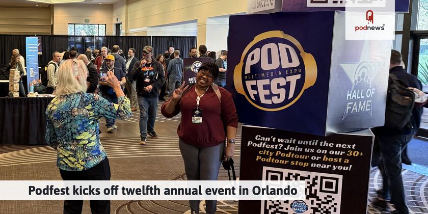 Attendees grab a selfie in front of the Podfest signage