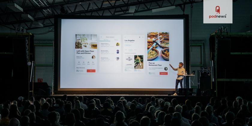 A man giving a presentation in a big room