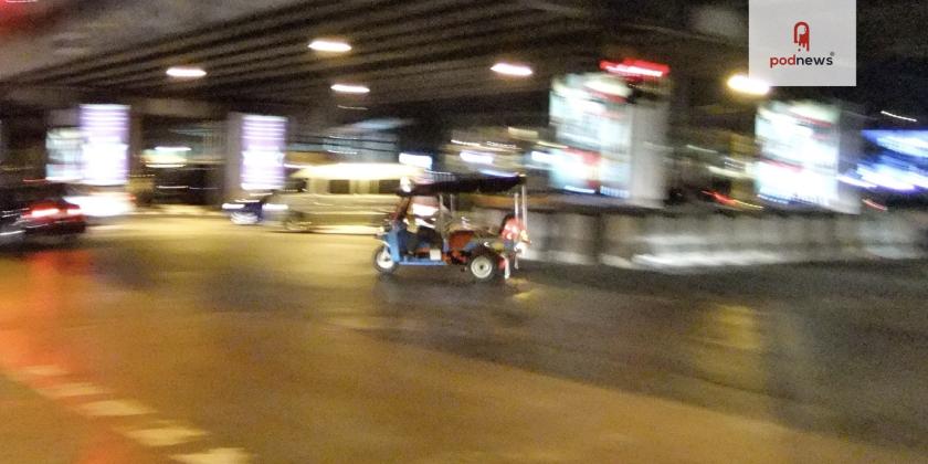 A tuk tuk speeds under a Bangkok underpass in 2010