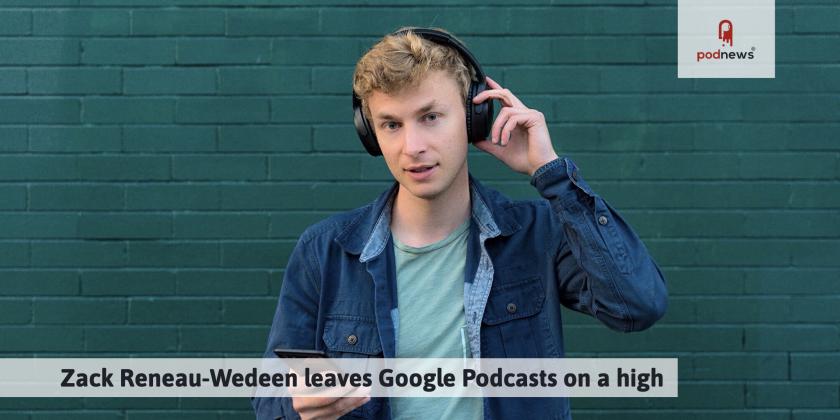 A picture of Zack Reneau-Wedeen, wearing headphones and listening to his mobile phone